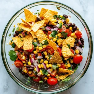 Fiesta Fritos Corn Salad is an irresistible and vibrant dish that beautifully encapsulates the essence of summer eating. Bursting with color, texture, and flavor, this salad combines sweet corn, crunchy Fritos, and a medley of fresh vegetables, making it a perfect side dish for barbecues, picnics, or casual family dinners. Not only does it offer a feast for the eyes, but it also serves as a refreshing counterpart to heavier main courses, making it a beloved choice during the warmer months.