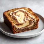 Banana bread is a beloved classic that has graced many breakfast tables and dessert platters for generations. Its irresistible aroma wafts through homes, warm and inviting, beckoning family and friends to indulge. Whether served fresh from the oven or toasted with a spread of butter, banana bread is comforting and satisfying. With myriad variations, one standout is the Creamy Cinnamon Swirl Banana Bread, which introduces an element of richness with a delightful cream cheese layer swirling through the moist and flavorful cake.