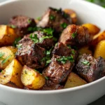 Delight in the rich flavors of Sizzling Garlic Steak Bites with Crispy Baby Potatoes. This dish combines tender, flavorful sirloin steak with golden-brown baby potatoes, all elevated by a fragrant garlic infusion. The sirloin steak is seasoned to perfection, seared to achieve a beautiful crust, and paired with crispy, melt-in-your-mouth potatoes, creating a delightful contrast of textures and tastes. Ideal for weeknight dinners, this recipe promises a satisfying and quick meal that's perfect for the whole family.