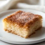 The Churro Cinnamon Sugar Poke Cake is a delightful dessert that brings the sweet, warm flavors of traditional churros into a soft, moist cake form. This easy-to-make recipe provides a unique twist on the classic poke cake by infusing it with sweetened condensed milk and topping it with a delicious cinnamon sugar blend. The combination of textures and flavors creates a snack that is both comforting and indulgent, making it a perfect companion for afternoon tea or a quick treat after dinner.
