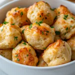 Exploring the world of gourmet appetizers, these Garlic Butter Lobster Biscuit Bites offer a luxurious twist on traditional biscuits. With their combination of tender biscuit dough infused with fresh lobster, enhanced by a rich garlic butter topping, they elevate any gathering, whether it’s a casual brunch or a formal dinner party. The sweet and delicate flavor of lobster, combined with the savory richness of garlic butter and the sharpness of cheddar cheese, creates a delightful explosion of taste in every bite. Perfect for seafood lovers, these biscuit bites bring sophistication to the table and are sure to impress your guests.