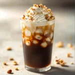 The resurgence of cold brew coffee has captured the hearts of coffee enthusiasts everywhere, offering a smooth and refreshing alternative to traditional hot brews. This Vanilla Hazelnut Cold Brew Delight embodies a perfect blend of flavors and creamy textures. The combination of rich coffee, sweet vanilla syrup, and nutty hazelnut syrup makes it an ideal choice for warm days or as a delightful morning boost. The passionate use of cold water in the brewing process allows the coffee to develop nuanced flavors without the bitterness often associated with hot brewing methods.