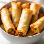 Exploring the delightful world of crispy air fryer spring rolls brings vibrant flavors and textures to your dining table. This plant-based appetizer is a fantastic way to enjoy fresh vegetables wrapped in a light, crispy exterior. Bursting with the freshness of shredded carrots, cabbage, bean sprouts, bell peppers, mushrooms, and green onions, these spring rolls not only look appealing but also deliver a satisfying crunch in every bite. The use of an air fryer not only quickens the cooking process but also creates a healthier version compared to traditional frying methods.